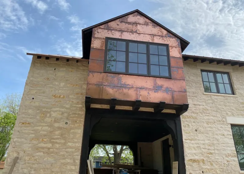 Copper metal panel facade on a stone building for Skylight Installation in Carpentersville