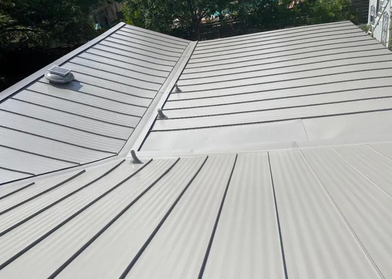 Solar attic fan installed on a metal roof for Roof Ventilation in Carpentersville